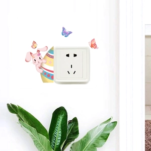 Detail of Easter bunny wall stickers with colorful butterflies around a power outlet