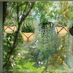 Detail of hand-painted watercolor hanging plant window stickers and colorful butterflies
