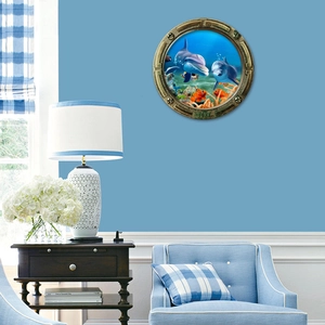 Close-up of a 3D ocean porthole wall sticker showing dolphins and coral reef on a blue wall