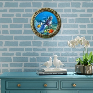 3D porthole wall sticker featuring a mermaid and tropical fish in a golden frame