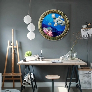 3D porthole wall decal featuring a vibrant coral reef and tropical fish in a study room