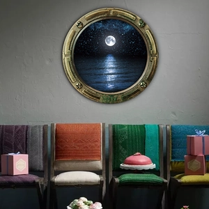 Detail of vintage brass submarine porthole wall sticker featuring a moonlit sea view
