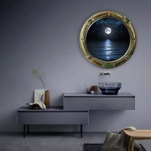 Detail of nautical porthole wall decor featuring brass frame and serene moonlight sea scene