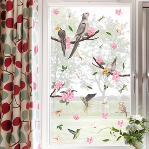 Nature wall stickers with birds and pink cherry blossoms on a glass window surface