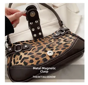 Close-up of leopard print shoulder bag featuring a secure magnetic hardware buckle closure