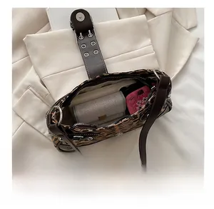 Top view showing large capacity of the leopard print shoulder bag with interior essentials