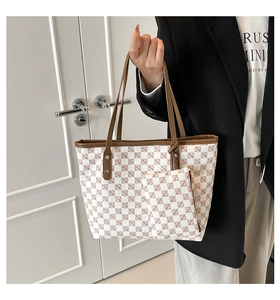 Detail view of cream tote bag with brown geometric pattern and matching small coin purse
