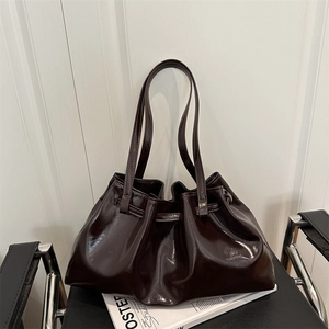 Dark brown oil wax leather tote bag with stylish side pleats and slim shoulder straps
