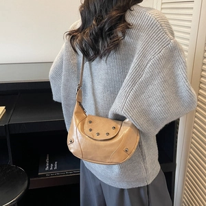 Minimalist crescent shoulder bag in light brown PU leather with stylish rivet details