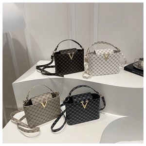 Detailed display of four textured bucket bags with geometric patterns and golden V buckles