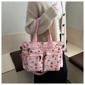 Pink cherry print tote bag featuring multiple front zip pockets and adjustable strap