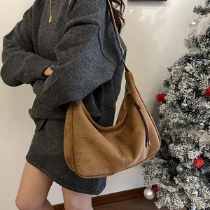 Brown large suede hobo shoulder bag with zipper detail for winter fashion styles