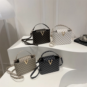 Vintage printed small square handbags in four colors with gold V buckle on display stand