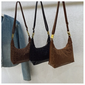 Detailed leopard embossed textures of three stylish shoulder bags in brown and black