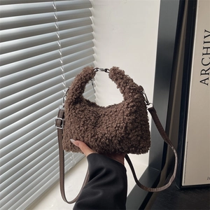 Brown teddy fleece handbag with plush texture and adjustable leather strap for women