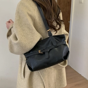 Chic black leather underarm shoulder bag with golden buckle straps for 2025 winter style