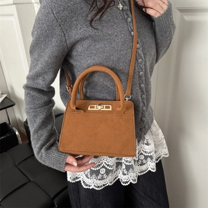 Elegant brown suede trapezoid handbag with gold twist lock for autumn winter