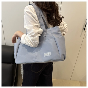 Side view of a light blue large capacity tote bag with dual wide shoulder straps