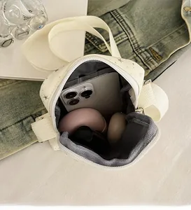 Interior view of white star print crossbody bag showing spacious storage for makeup and phone