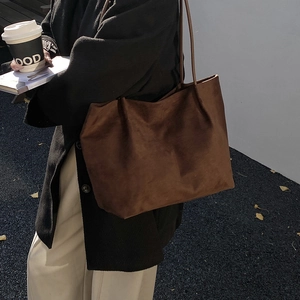 Minimalist large brown suede tote bag with soft leather texture and elegant shoulder strap