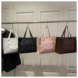 Macro view of tote bags in four colors with embossed M logo and letter patterns