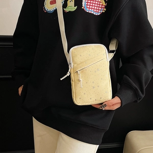 Chic yellow canvas crossbody bag with white star pattern and adjustable shoulder strap