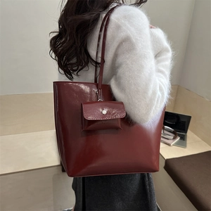 Large dark wine red glossy leather tote bag with small matching pouch on shoulder