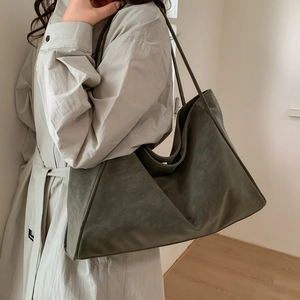 Side view of a large olive green tote bag showing the unique triangular side structure