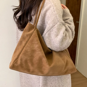 Brown vintage suede tote bag shown on model shoulder for large capacity daily use