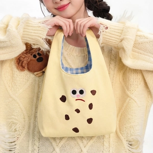 Cute yellow canvas cookie tote bag with embroidered cartoon face and blue plaid lining
