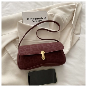 Detail of burgundy leopard print shoulder bag with gold metal U-shaped buckle