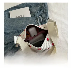 Interior view showing large capacity of the corduroy strawberry print shoulder bag