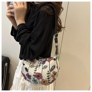 Detailed texture of a corduroy floral underarm bag with vintage floral patterns and strap