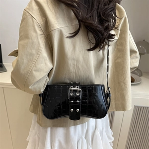 Elegant black crocodile-patterned crossbody bag with silver buckle and slim strap