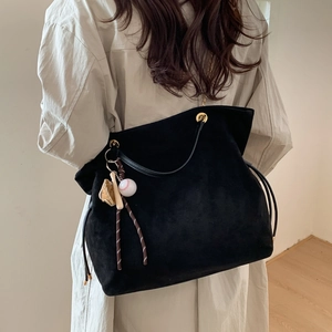 Vintage black matte suede tote bag for women with a cute baseball charm and drawstring closure
