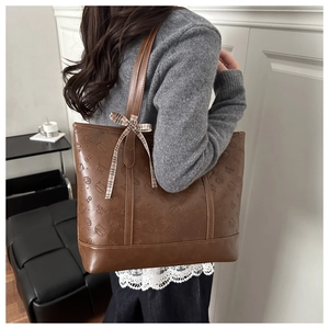 Brown textured faux leather tote bag with cat embossing and checkered bow detail