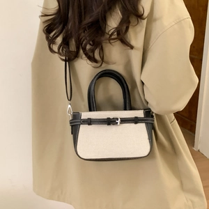 Retro canvas and leather crossbody bag with adjustable strap and metal buckle detail