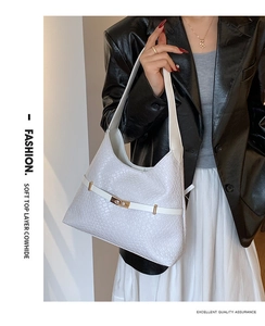 Detail of white woven soft cowhide hobo bag featuring gold buckle and leather strap