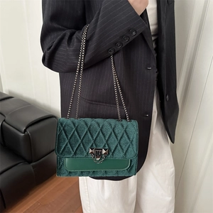 Forest green velvet crossbody bag with diamond quilting and silver chain strap for women