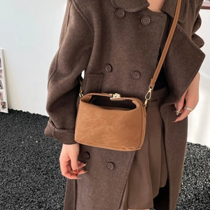 Caramel brown suede crossbody bag with vintage gold buckle and slim leather strap