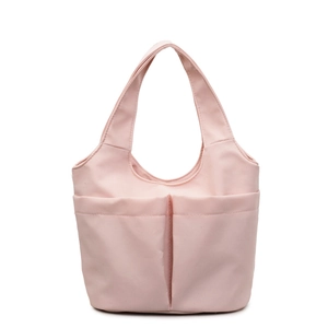 Minimalist light pink nylon bucket tote bag with dual front pockets on white background