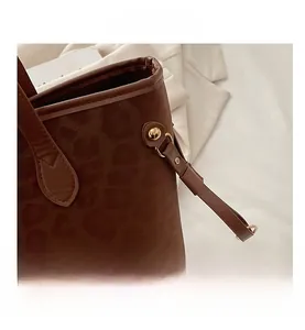 Macro detail of leopard print tote bag featuring premium suede texture and gold rivets