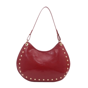 Red glossy patent leather half-moon shoulder bag with golden studs and vintage punk style