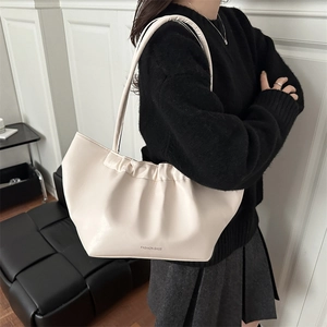Chic cream ruched shoulder bag with Fashion Bags print in a minimalist interior setting