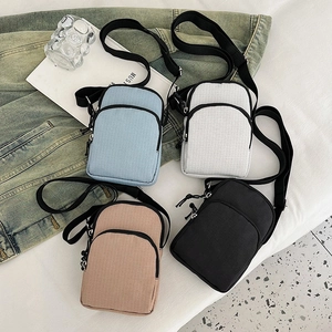 Minimalist crossbody phone bags in four colors with dual zipper layers and adjustable straps