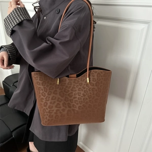 Leopard print tote bag with brown slim straps and gold metal hardware for women