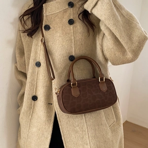 Brown leopard print mini handbag in cylindrical shape with adjustable strap and gold hardware