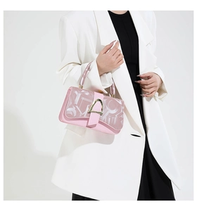 Pink crossbody bag with logo pattern, gold metal buckle and wrapped top handle