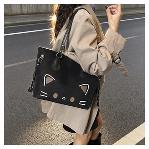 Detail of minimalist cat pattern on black matte leather tote bag with city backdrop
