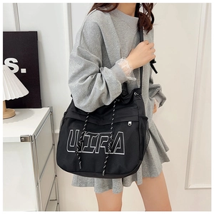 Detail of black large capacity drawstring bucket bag with ULTRA graphic and side mesh pocket